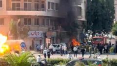 Explosions Rock Damascus Amidst French Presidential Visit, Injuring 18